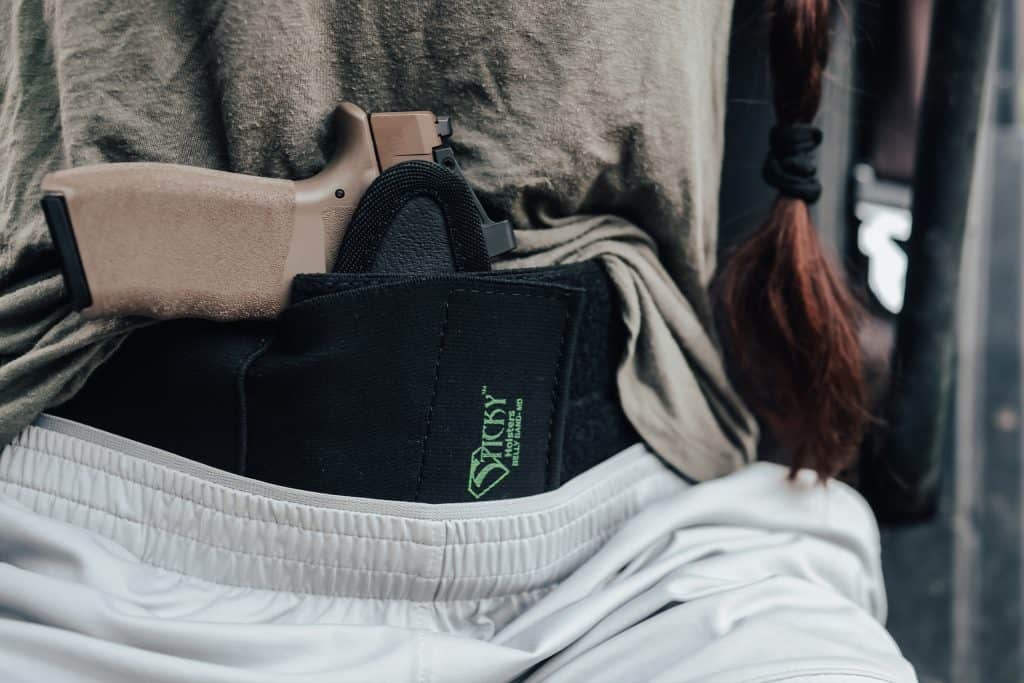 Woman with a sticky holsters holster concealed in her waistband