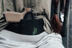 Woman with a sticky holsters holster concealed in her waistband