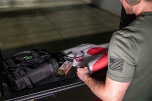 Sticky Holsters Roll Out Range Bag with shooting range gear and target.