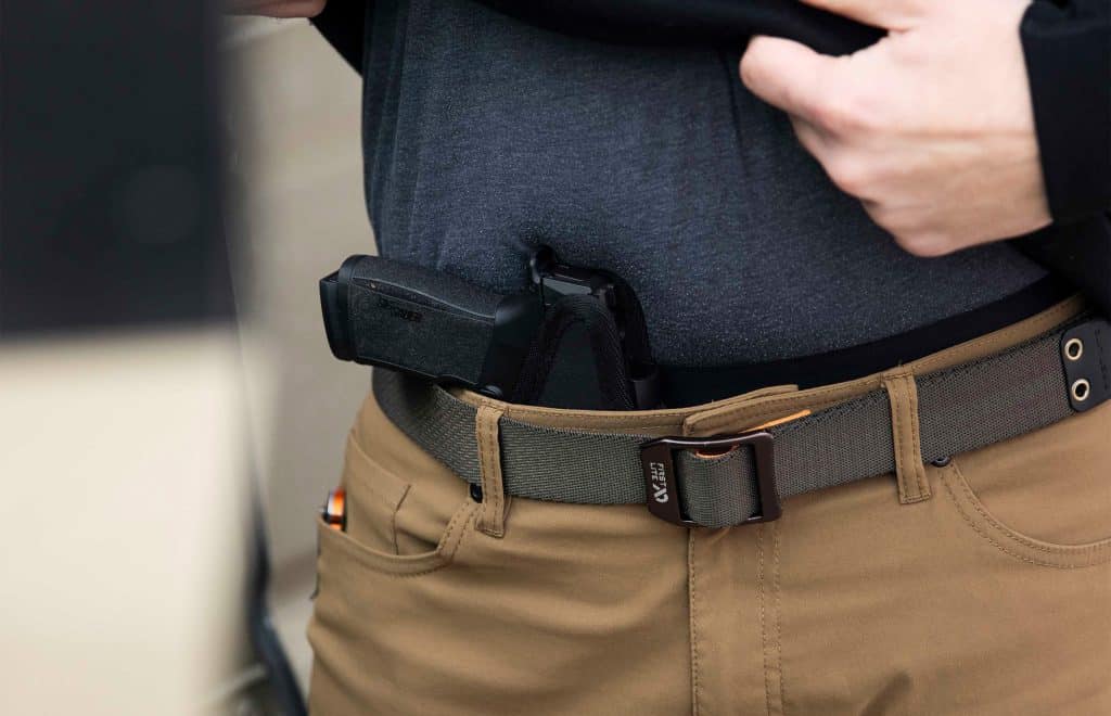 Man carrying a concealed handgun with a Sticky Holster.